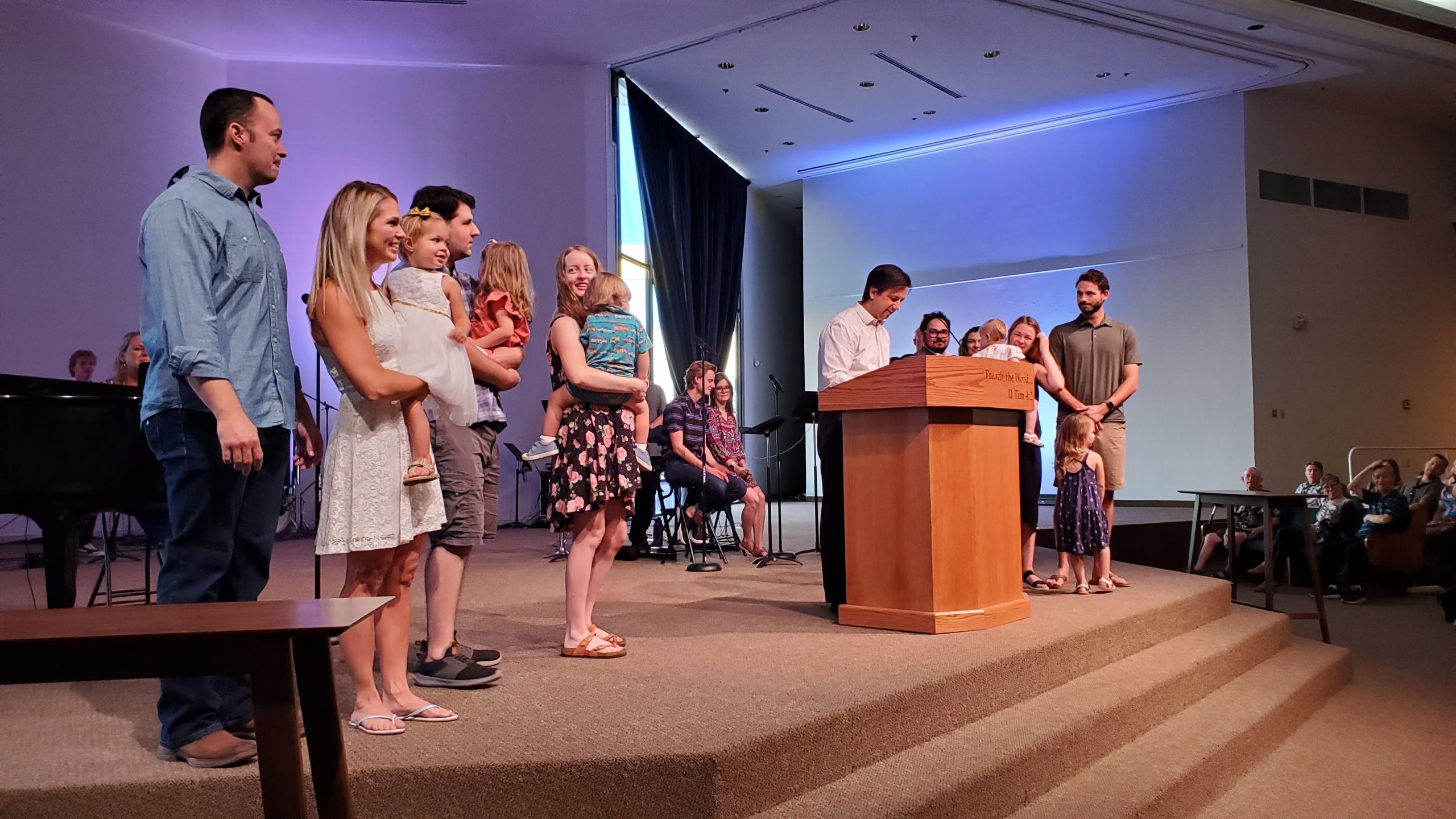 families on stage at church