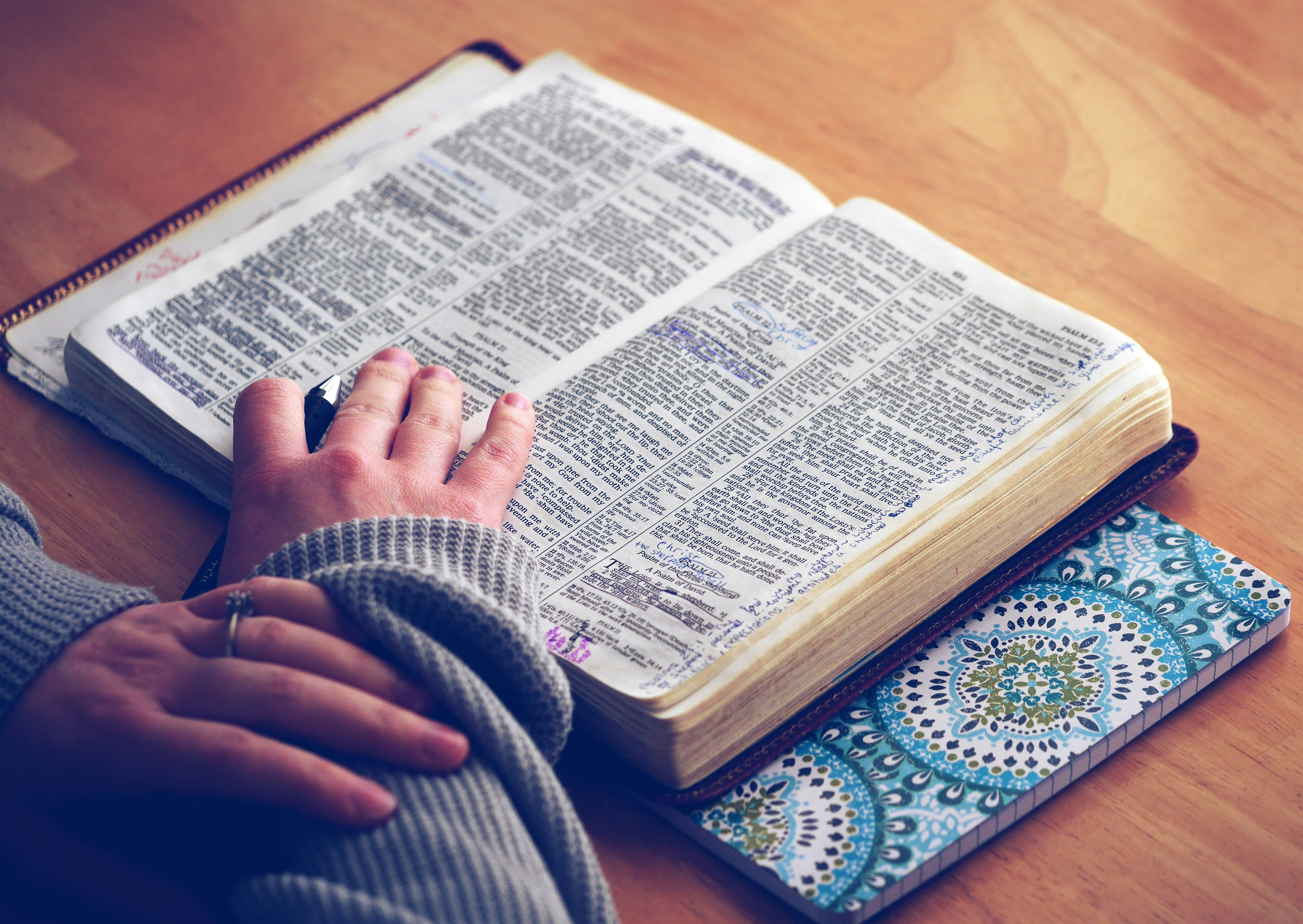 woman's hand on Bible