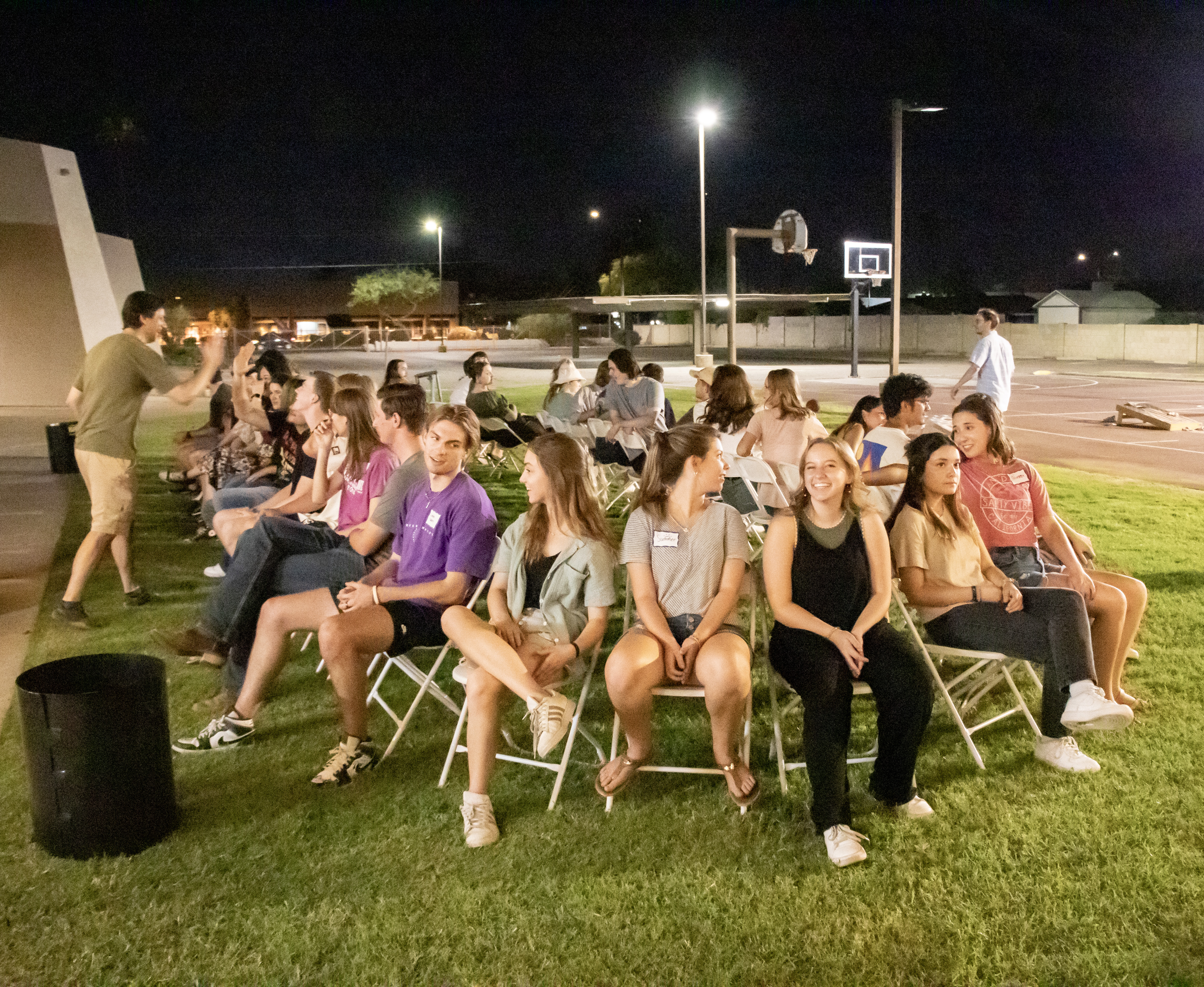 Young Adults playing musical chairs